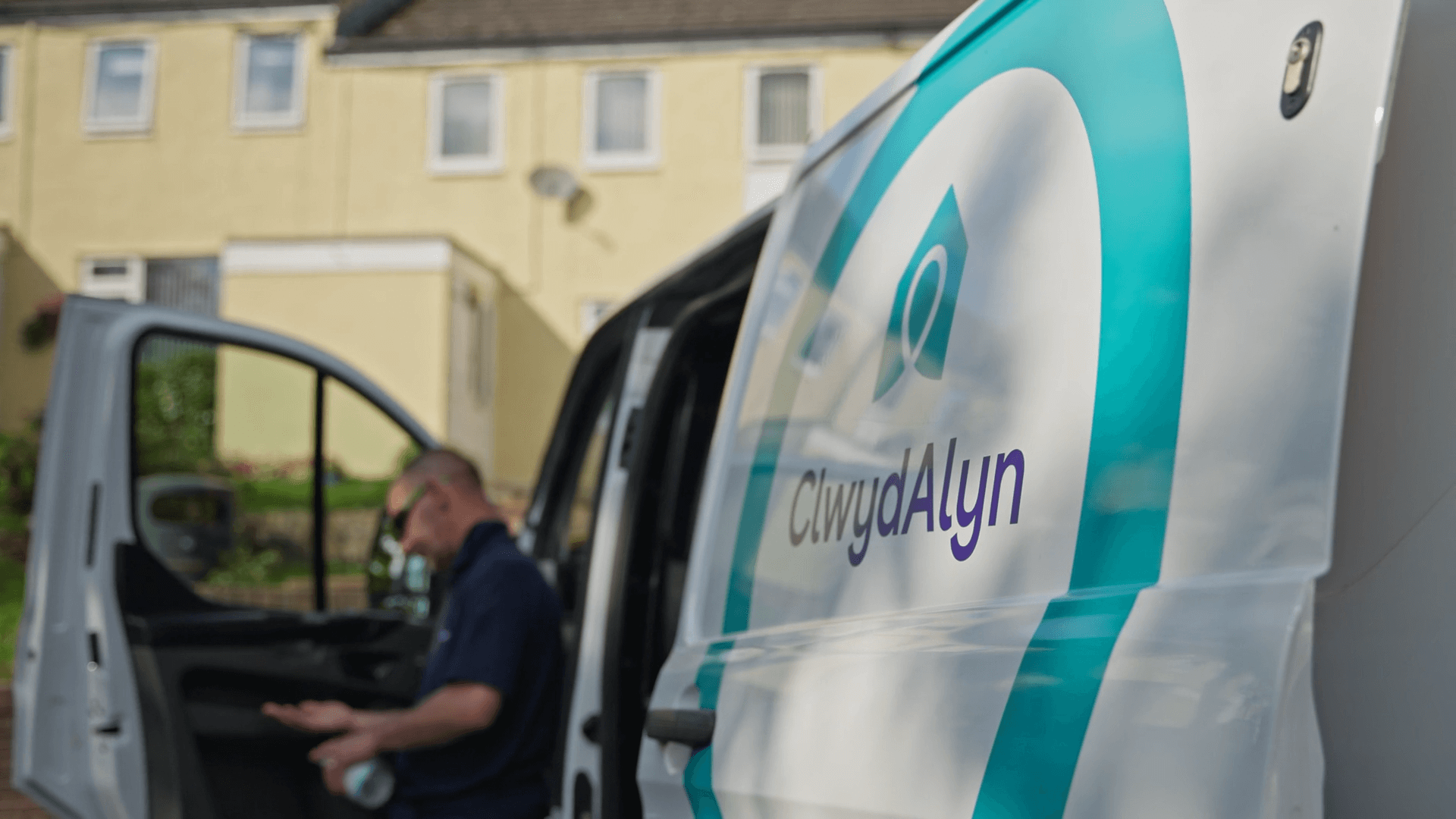 Plumber & Electrician stepping out of a ClwydAlyn van