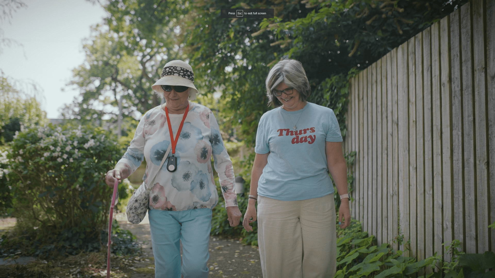 Resident and staff walking in Merton Place