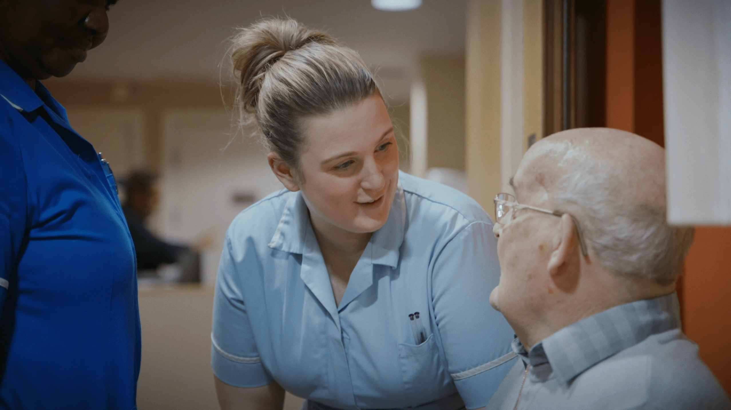 resident talking to staff at Merton Place, Colwyn Bay