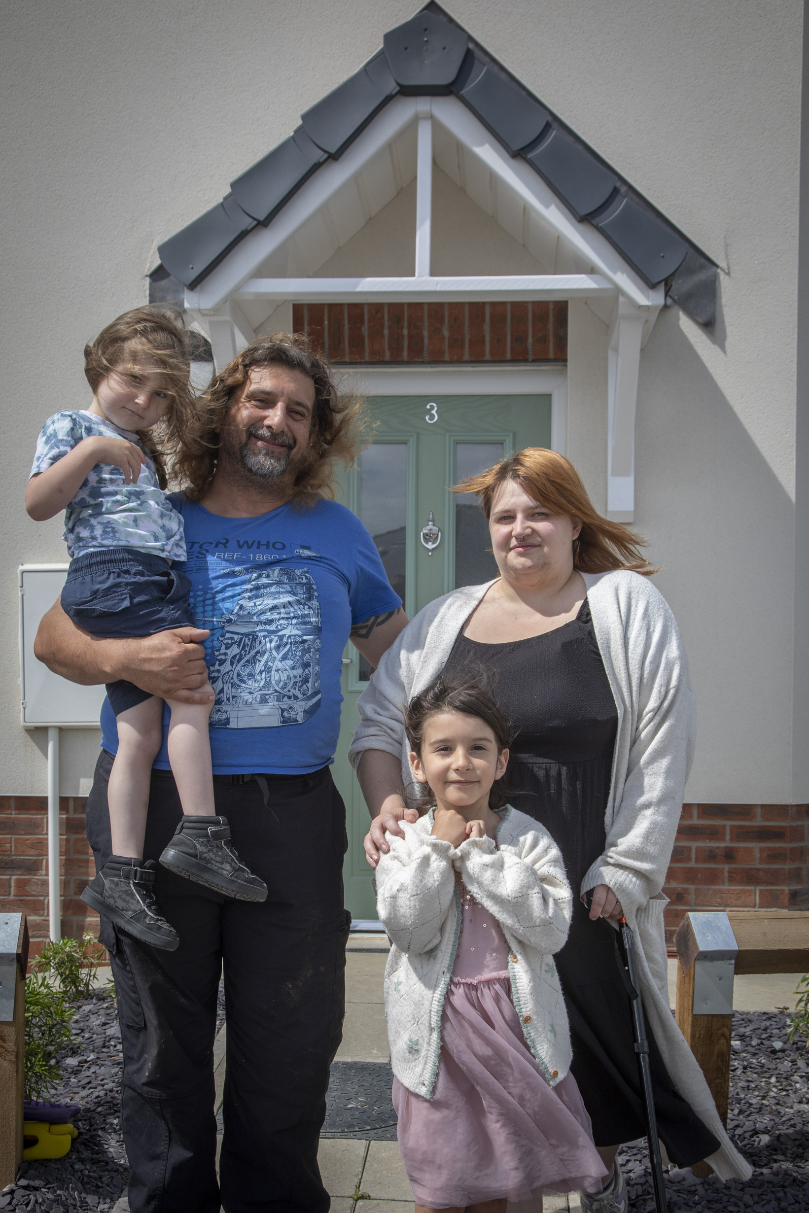 Family outside new home at Coleg Menai site in Llangefni