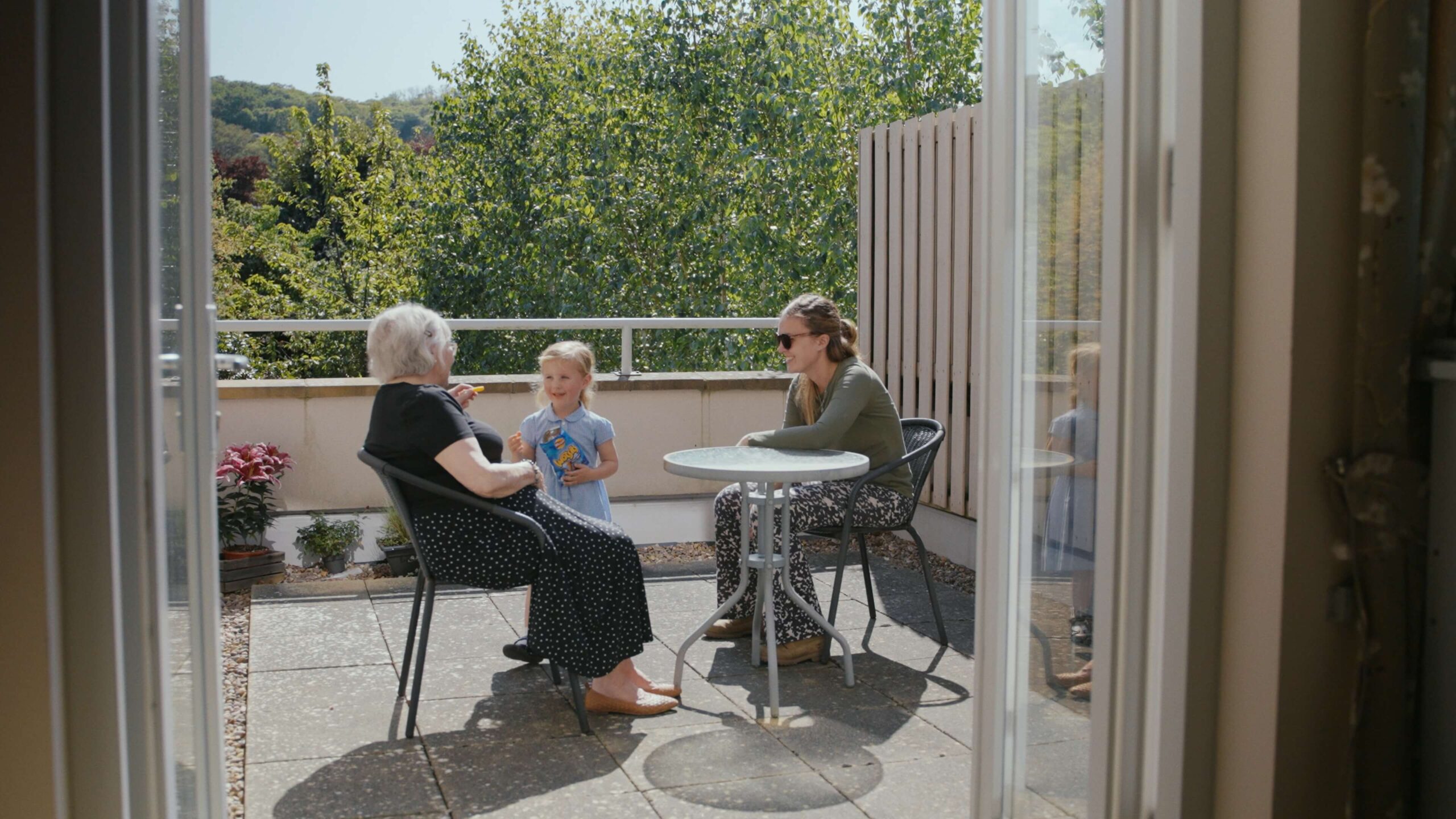 Mother, grandchild and daughter on the balcony of Merton Place